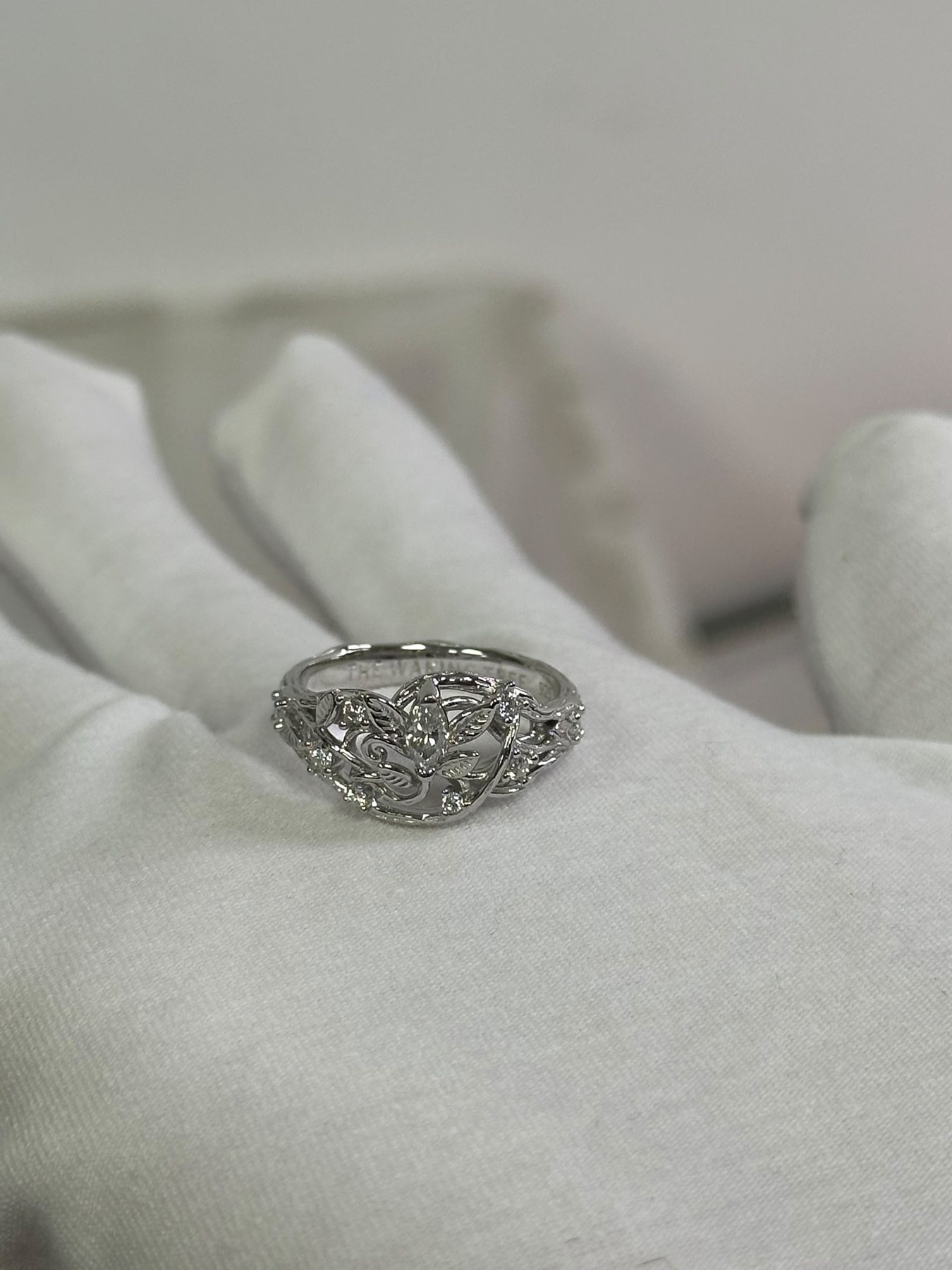 Bright silver ring resting in an open hand