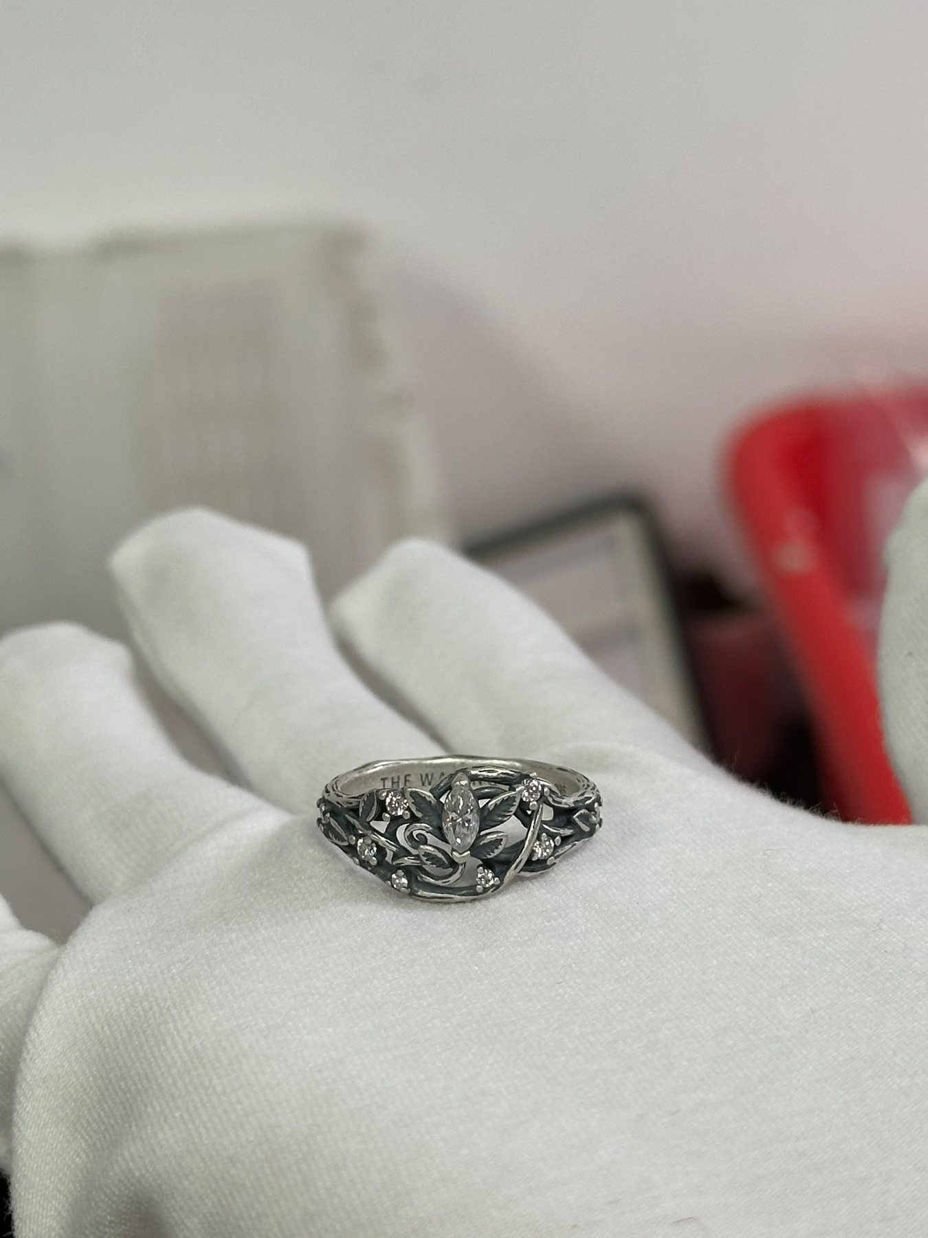 Oxidized silver ring resting in an open hand
